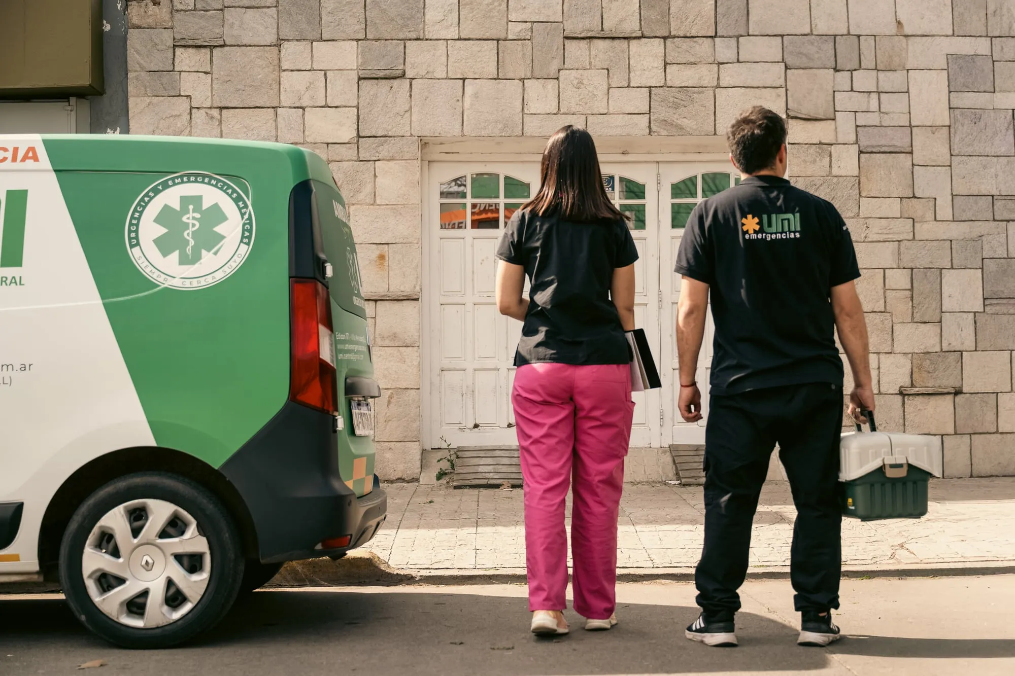 Médica y enfermero de UMI llegando a un domicilio para una visita